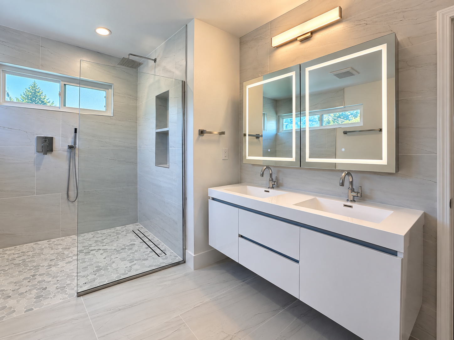 Primary bathroom alternate angle showing double vanity and walk-in shower